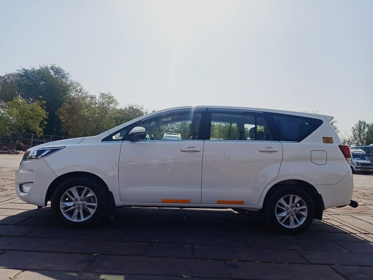White Toyota Innova Crysta, left-side view