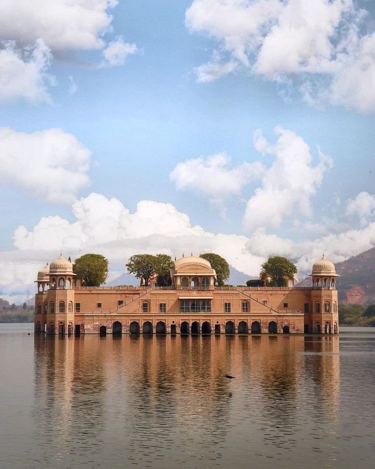 Jal Mahal beneath bright clouds over Jaipur